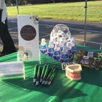 A table at an even covered in Tina Le DDS branded merchandise