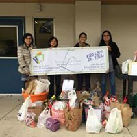 Dr. Tina Le and team holding a check and collecting donations